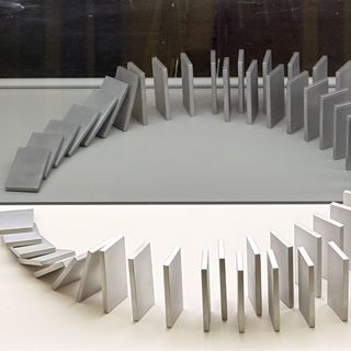 A set of dominoes falling into reflections. Picture taken at Harnacke House, Berlin.