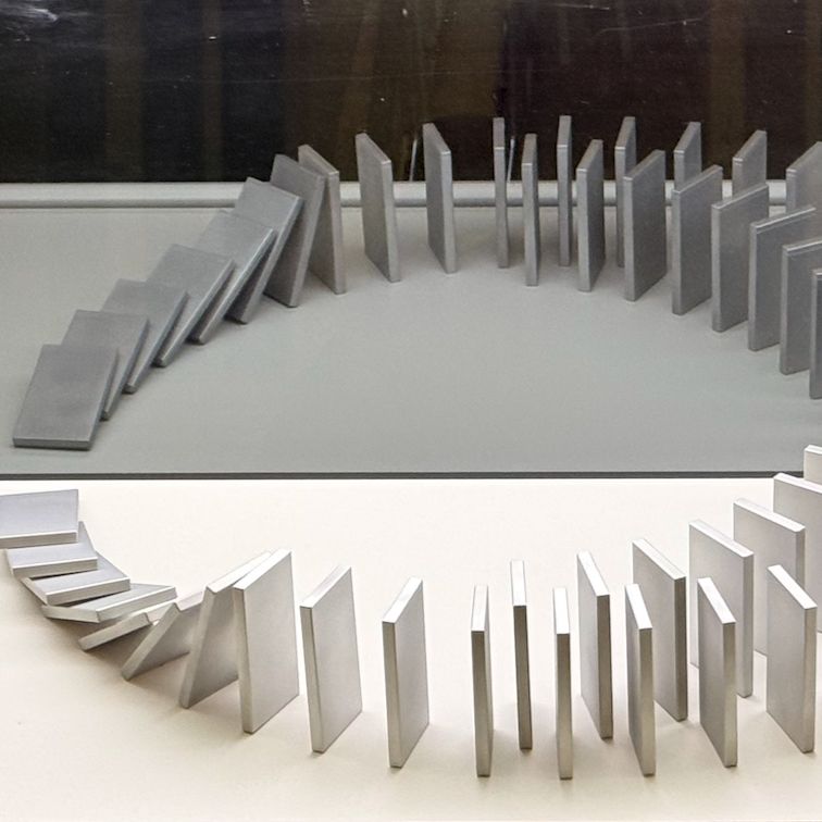 A set of dominoes falling into reflections. Picture taken at Harnacke House, Berlin.